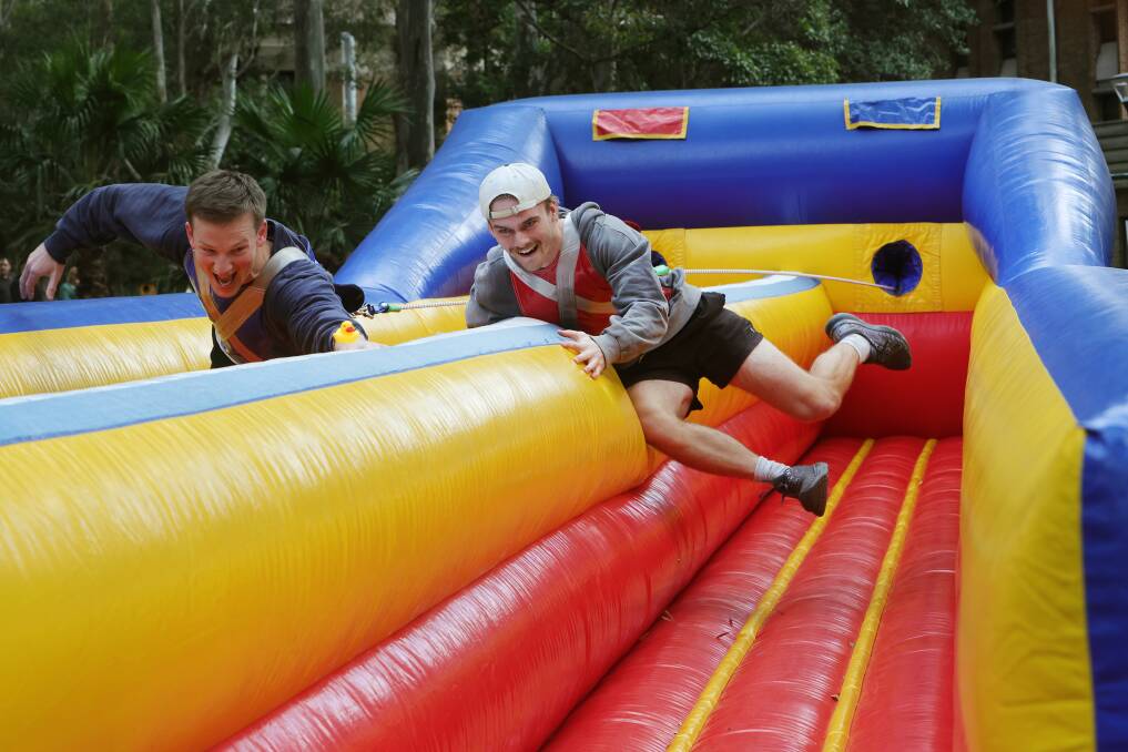 Brayden Begg and Jesse Payton launch themselves from the horizontal bungee at UOW's Open Day on June 22. Picture by Sylvia Liber