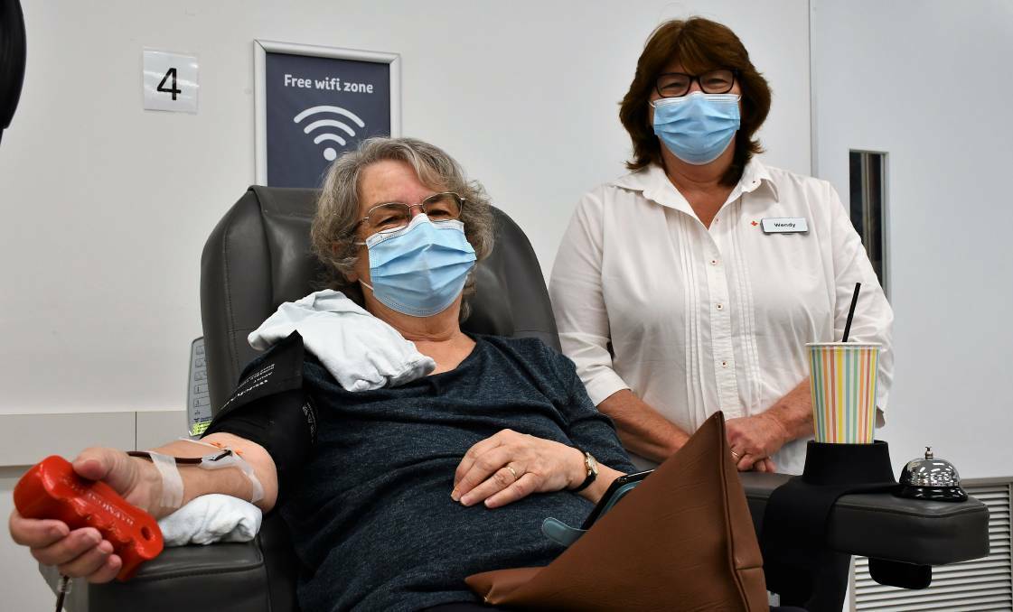 Christine Bernays donates blood with Lifeblood Goulburn centre manager Wendy Skelly. Picture: Hannah Neale
