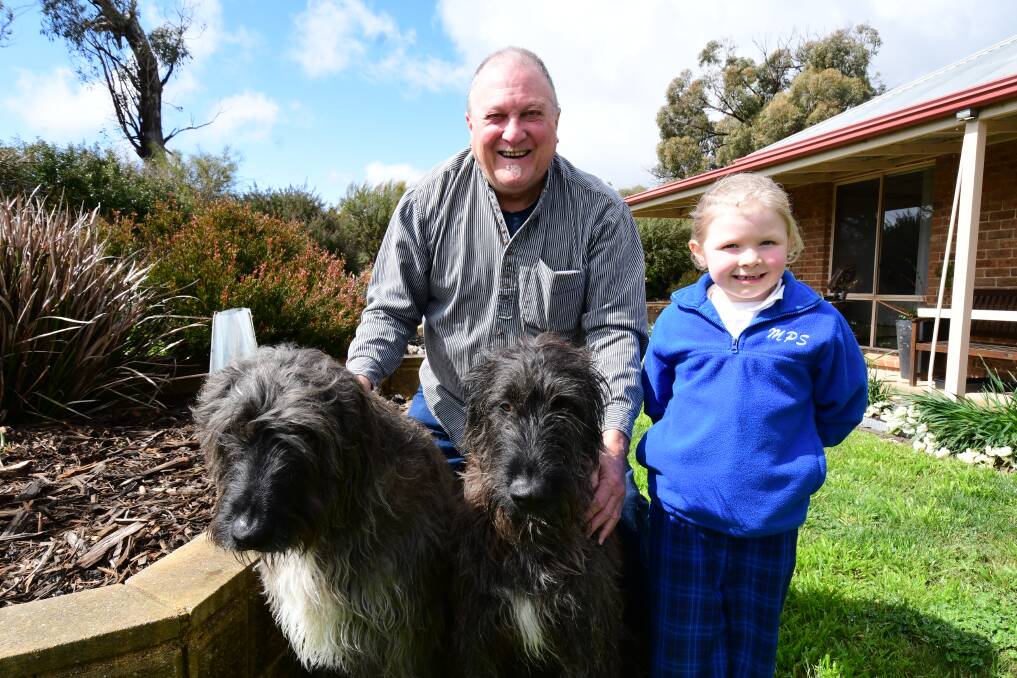 Irish wolfhounds, Finnegan and Logan, front, with Jim Whittaker and his granddaughter, Willow Whittaker. Picture by Jude Keogh.