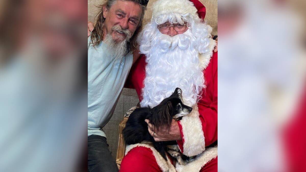 "We woof you a Merry Christmas" Moruya's Andy Hodson, 23 year old dog Rocky and Santa. 
