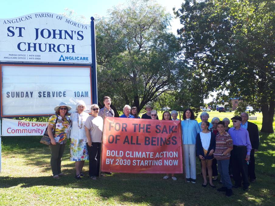 St Johns' Anglican Church Moruya raising their climate banner on Easter Sunday