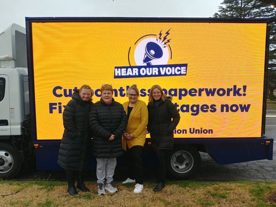 Teachers from St Joseph's Primary School with the IEUA's mobile billboard truck. Photo: Supplied.