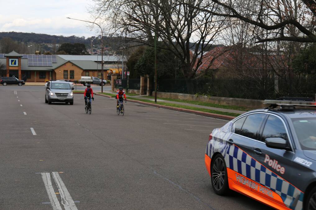 Police escorted Mr Whelan and Mr Evans up Montague Street as they arrived in Goulburn. Picture by Sophie Bennett