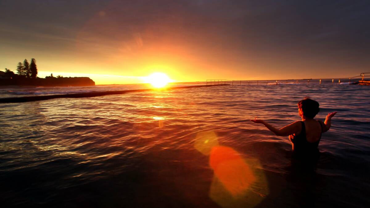 A woman partakes in the rising of the Sun on the day of the Winter solstice at Austinmer, NSW. File picture