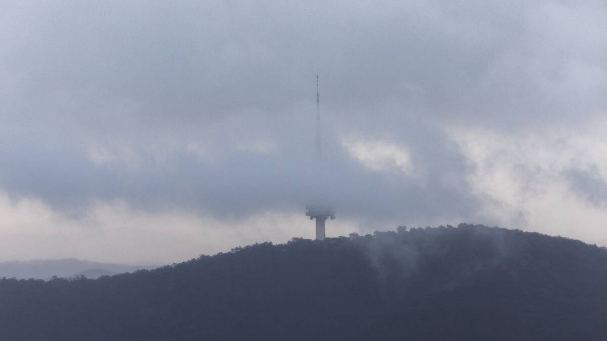 Pictured here, Canberra's Telstra Tower surrounded by clouds. Rain and possible thunderstorms are in store for the region. Picture by Gary Ramage. 