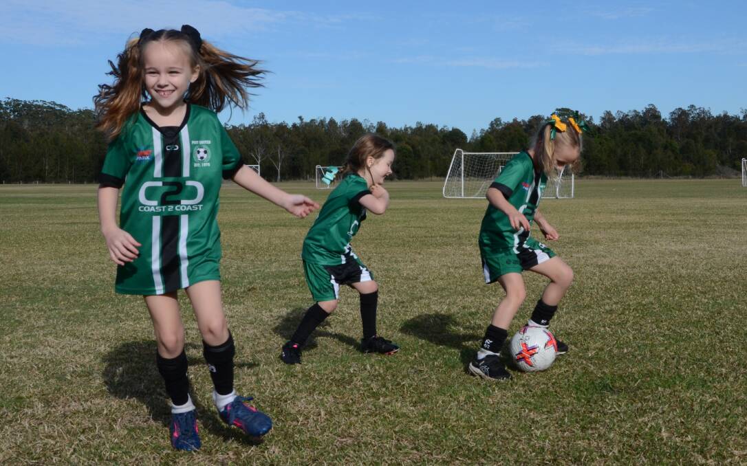 Port United under 6's Matildas teammates Isobel Frazer, Olivia Curral and Ella Storrier love playing on the fields. Picture by Emily Walker