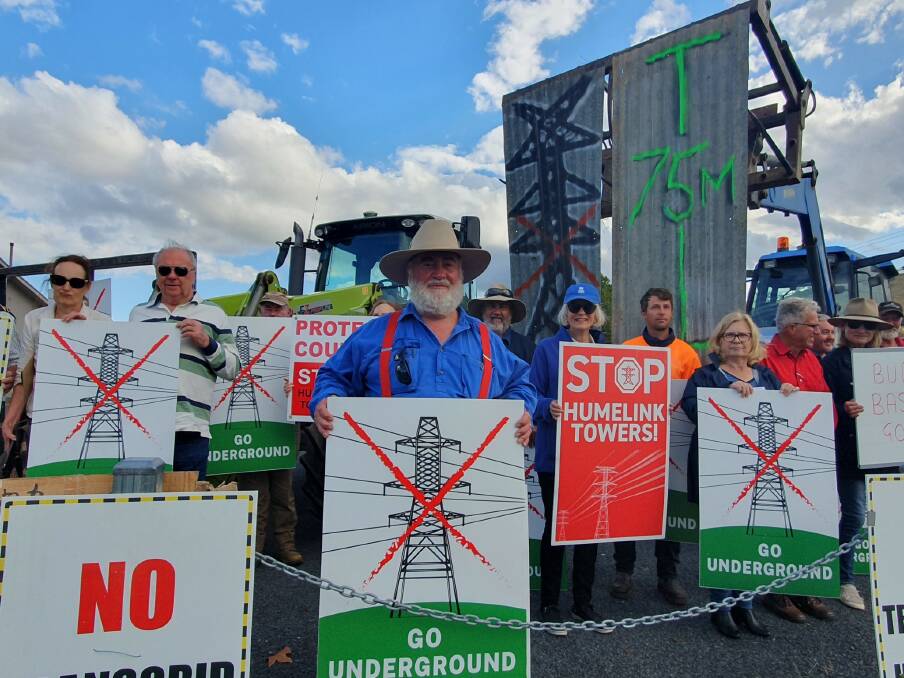Bill Kingwill (centre) pictured with fellow HumeLink protesters outside TranGrid's community consultation meeting in Gundagai. Picture by Rebecca Tobin