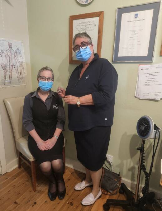 Annette Wetherspoon, who is a recovering breast cancer patient, at Goulburn Medical Centre for her fifth COVID-19 vaccine. She is pictured with Dr Isabella Hawke. Photo supplied.