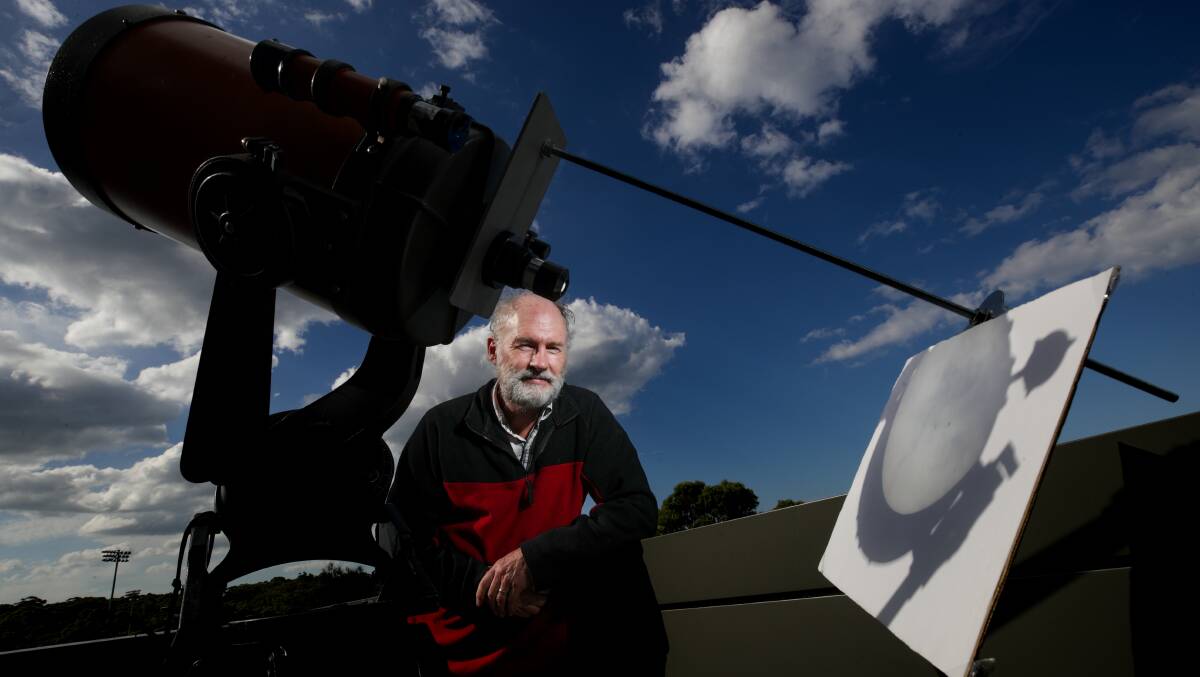 University of Wollongong Associate Professor Nicholas Jones with a telescope projecting the sun onto a board. Picture by Adam McLean
