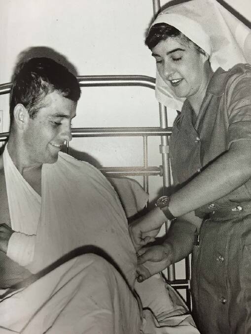 Terrie Roche secures a sling on an Australian soldier at the 8th Field Ambulance, Vung Tau. Photo: Dennis Stanley Gibbons