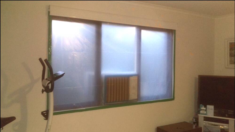 A window taped-up to keep smoke out of the Boltons' home. Picture supplied