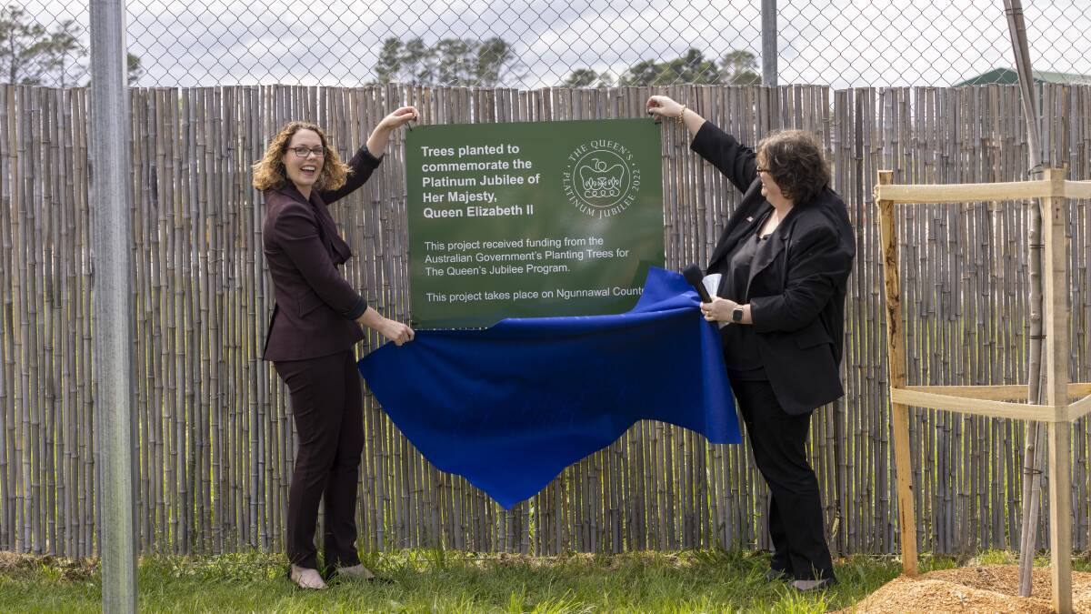 Canberra MP Alicia Payne and Argyle Housing CEO Carolyn Doherty unveil a plaque for the community tree planting project for the Queen's Jubilee, which was planted next to the Good Works Garden. Picture by Keegan Carroll