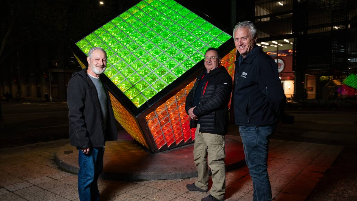  Ilumicube creator Kerry Simpson with Sound Advice lighting specialist Brett Fraser and managing director Norman Korte at the 'turning back on' of the artwork on Thursday night. Picture by Elesa Kurtz