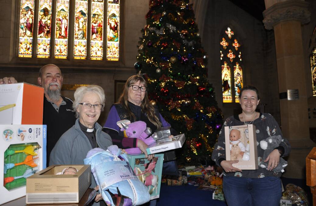 Goulburn Anglicare's Ivan Wilson (left), Dinah Haynes and Toni Reay joined Saint Saviour's Cathedral Sub-Dean, Canon Ann Wentzel to celebrate the joint annual Christmas appeal this week. Hundreds of presents have been donated to those in need. Picture by Louise Thrower.
