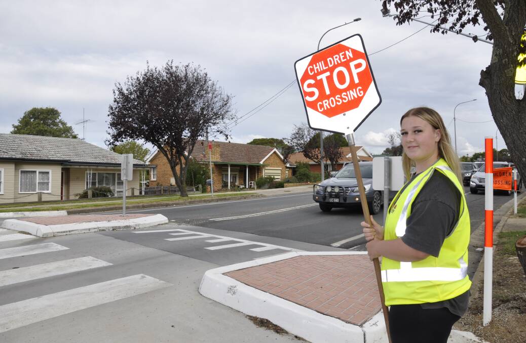 School crossing children's supervisor, Jakisha Bradbury, helped students safely traverse Fitzroy Street on Friday afternoon, as Wollondilly Public School broke up for holidays. Picture by Louise Thrower.