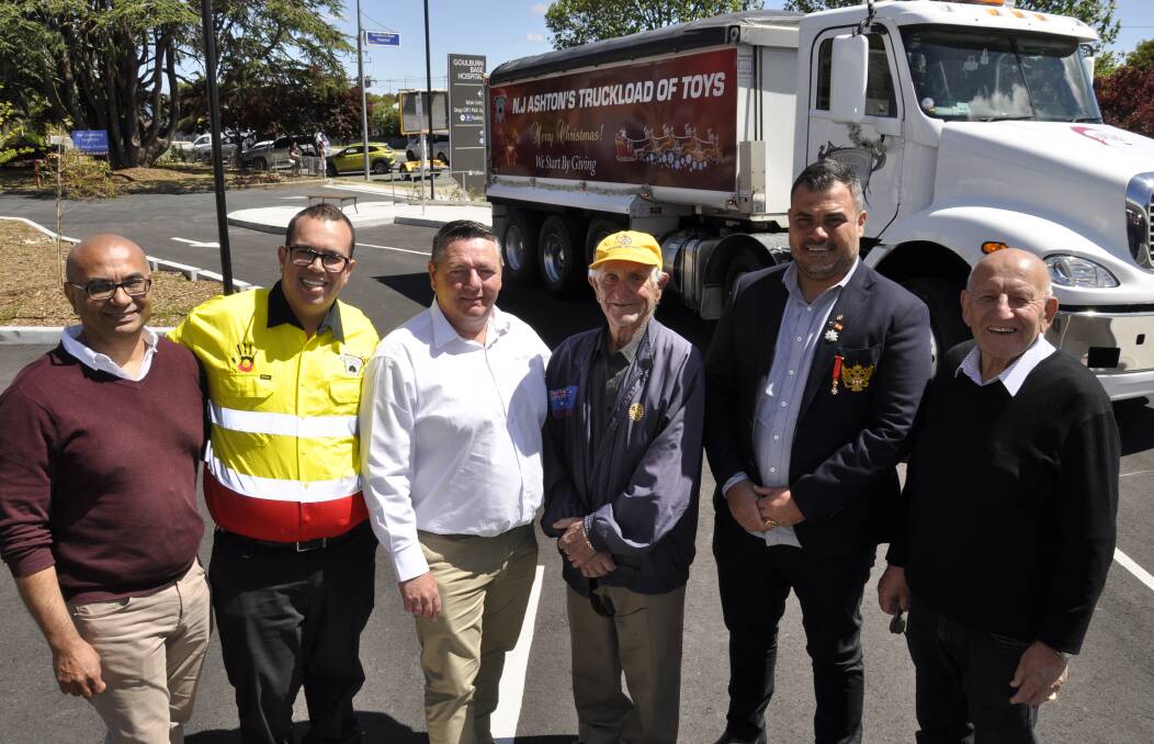Errol Pinto, Richard Donovan, NJ Ashton CEO Darren Parrington, Tony Lamarra and Peter Mylonas (right) joined NJ Ashton owner Norman Yammine (second right) in delivering toys from the truck to Goulburn Base Hospital on Friday. Picture by Louise Thrower.