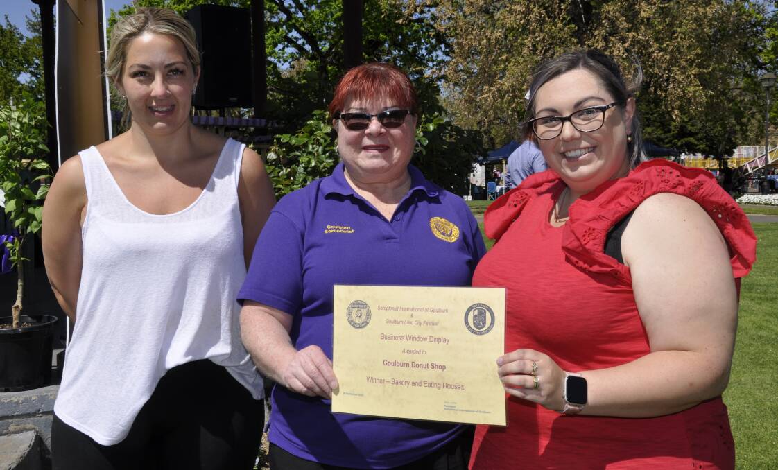Natalie Gray and Ashkey Webber accepted the window display winner's award for the bakery and eating houses category from Goulburn Soroptimists president, Sue Latta. Picture supplied. 