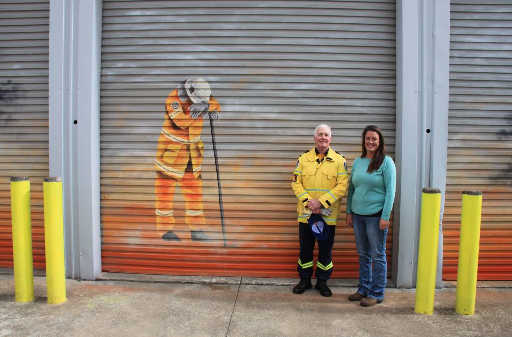 Taralga RFS captain John Sullivan and artist, Amy Curran, were thrilled with the result. Picture supplied.