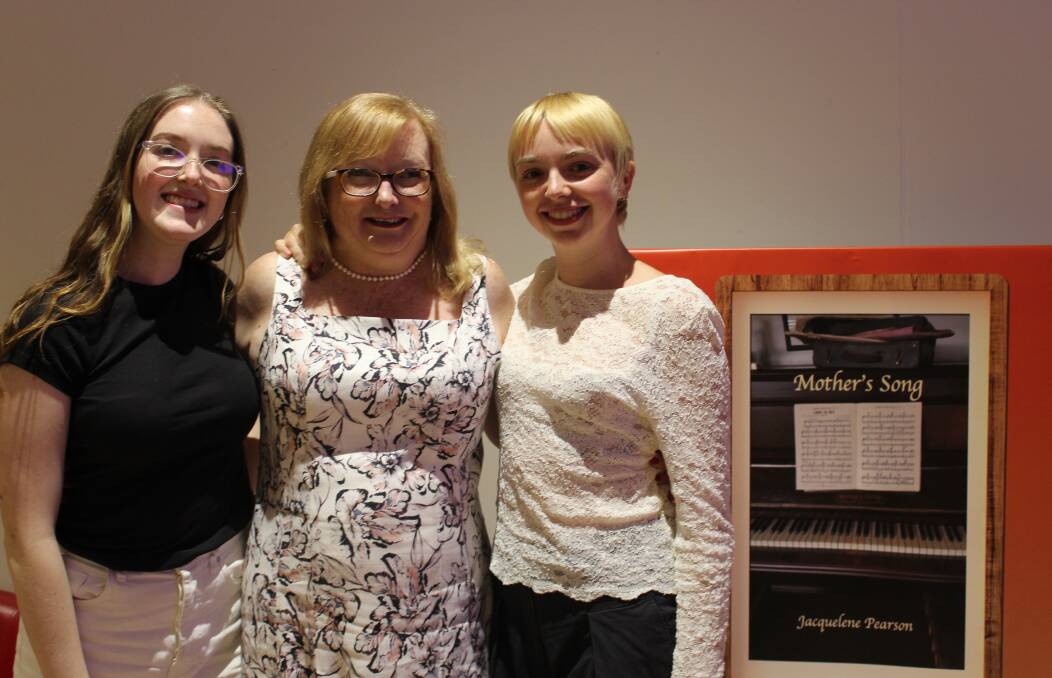 Jacquelene Pearson (centre) with her daughters Olivia and Jessica at the Central Coast launch of her poetry book, 'Mother's Song.'