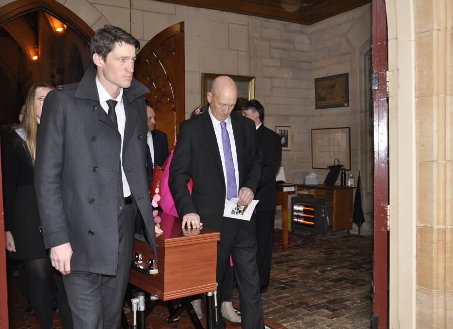 Mark and Julian Paviour emerge from Saint saviour's Cathedral with the casket. Picture by Louise Thrower.