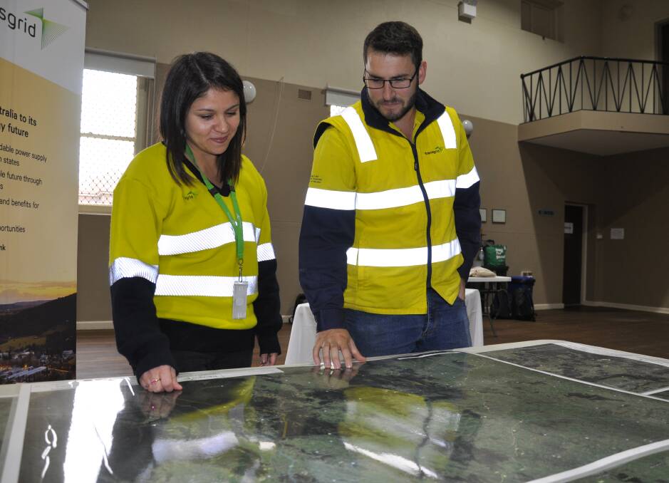 TransGrid's HumeLink community and stakeholder engagement manager, Katia Salazar and project engineer, Andrew Day, peruse maps at the Taralga community engagement session on Wednesday. Picture by Louise Thrower.