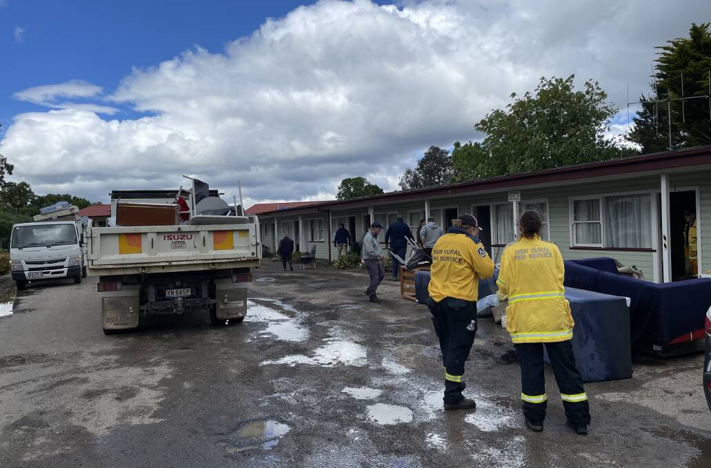 RFS volunteers pitched in to clear the Gunning Motel of damaged furniture and fittings on Tuesday. Picture by RFS.