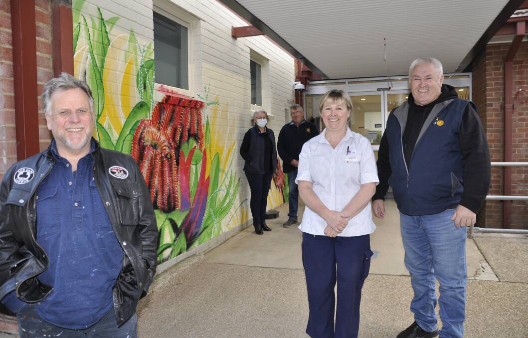 Signwriter Tony Marks completed a colourful public artwork for Goulburn Cancer Care Centre at the Base Hospital. He is with nurse unit manager, Christina Betts, Goulburn Rotary president, Steve Ruddell, hospital redevelopment project manager, Kerry Hort and Rotary member, Jock Robertson. Picture by Louise Thrower.