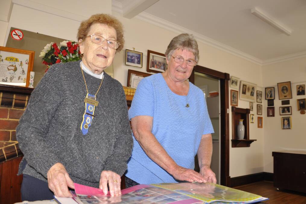 Goulburn CWA branch patron, Betty Campbell and president, Colleen Cooper, peruse historical photos. Picture by Louise Thrower.