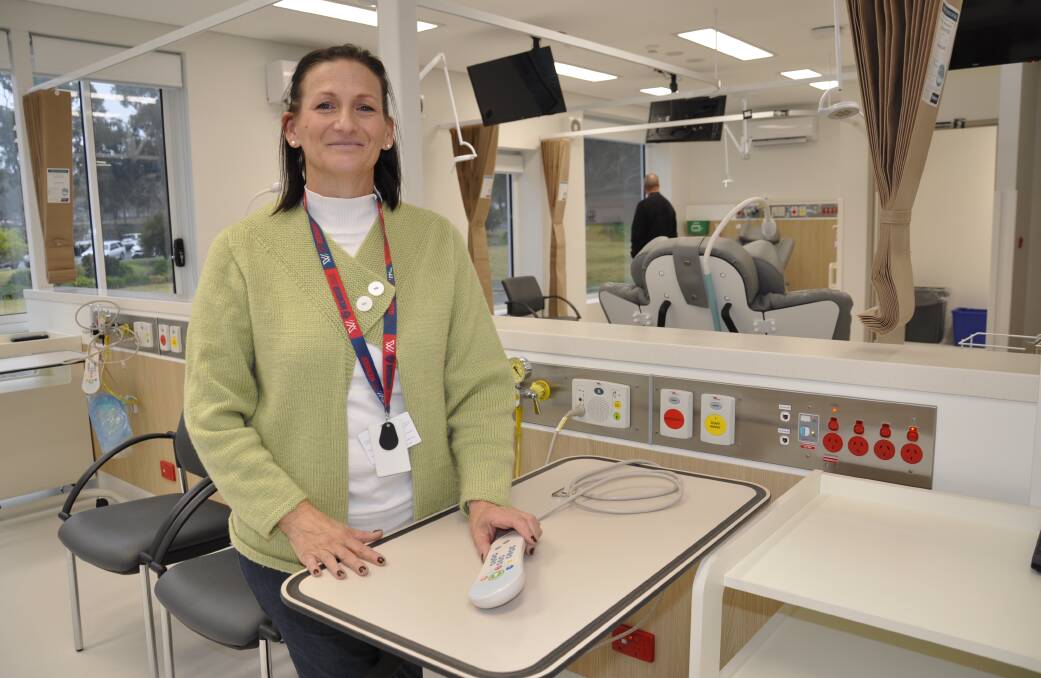 The hospital redevelopment change manager, Riki Mills in the new cancer care centre treatment room, complete with televisions that patients can watch during treatment. Picture by Louise Thrower.
