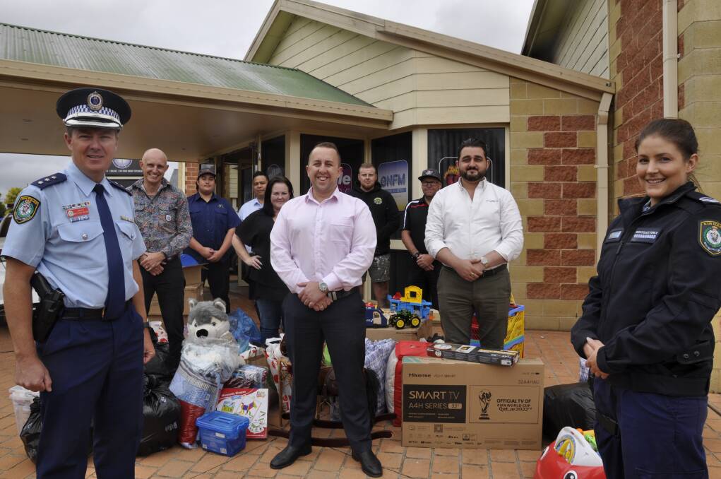 Inspector Matt Hinton, Dan Strickland, Capital Radio chief officer, Josh Matthews, Harvey Norman manager, Jay David and Senior Constable Charlotte Moran with supporters of the domestic violence victims interview room and hundreds of donations. Picture by Louise Thrower.