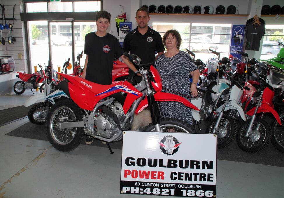 Matt Tremble (left) was thrilled to collect his new Honda bike from Goulburn Power Centre co-owner, Corey Peterson recently. Goulburn Make-A-Wish president, Sharon Wilson was also on hand. Picture by Darryl Fernance.