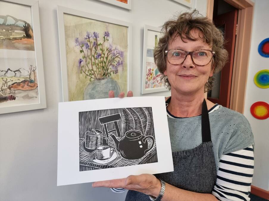 Artists and Creative Space owner, Barbara Nell with a limited edition linocut print that will be on sale for $50 at the Winter Exhibition and Sale on Friday night. The event, and an afternoon tea on Saturday, will raise money for the Cancer Council. Picture supplied. 