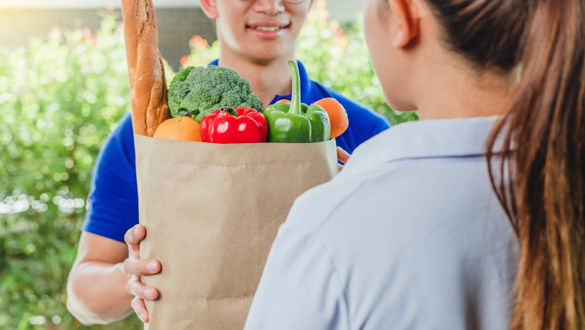 A woman receives a grocery delivery. Picture Shutterstock