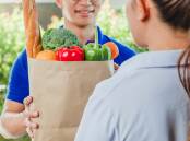A woman receives a grocery delivery. Picture Shutterstock