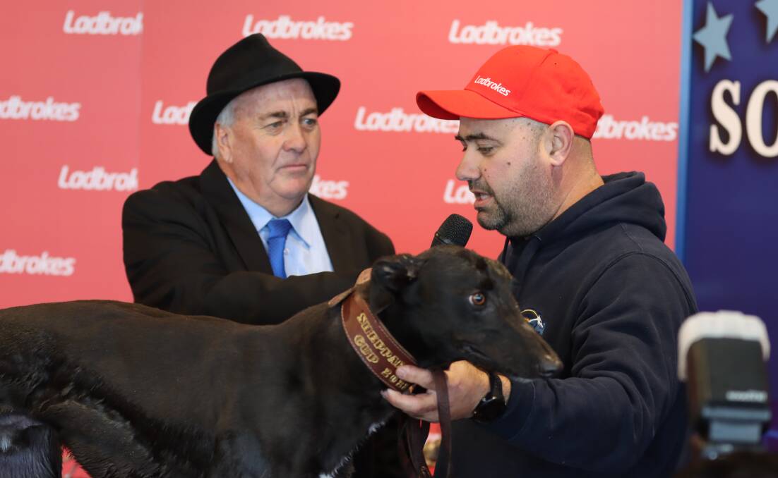 Anthony Azzopardi (right) with his chaser Big Daddy celebrate winning the $50,000 Ladbrokes Southern Stars final at the Goulburn Greyhound Racing Club on Friday. 