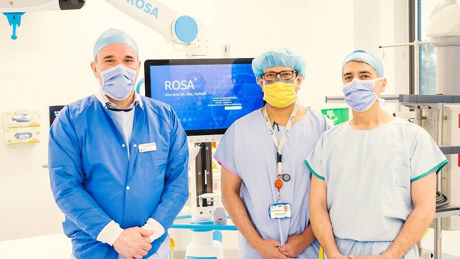 Dr Hamish Rae, Dr Arnab Banerjee and Dr Wisam Ihsheish with ROSA, the robotic surgery assistant aiding knee operations. Picture supplied. 