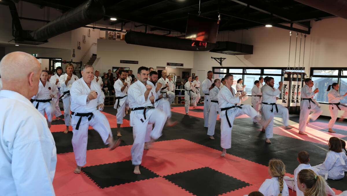 Black belts perform a kata at the Lambert Karate Dojo opening in November, with black belt instructors to lead free women's self defence courses next week. 
