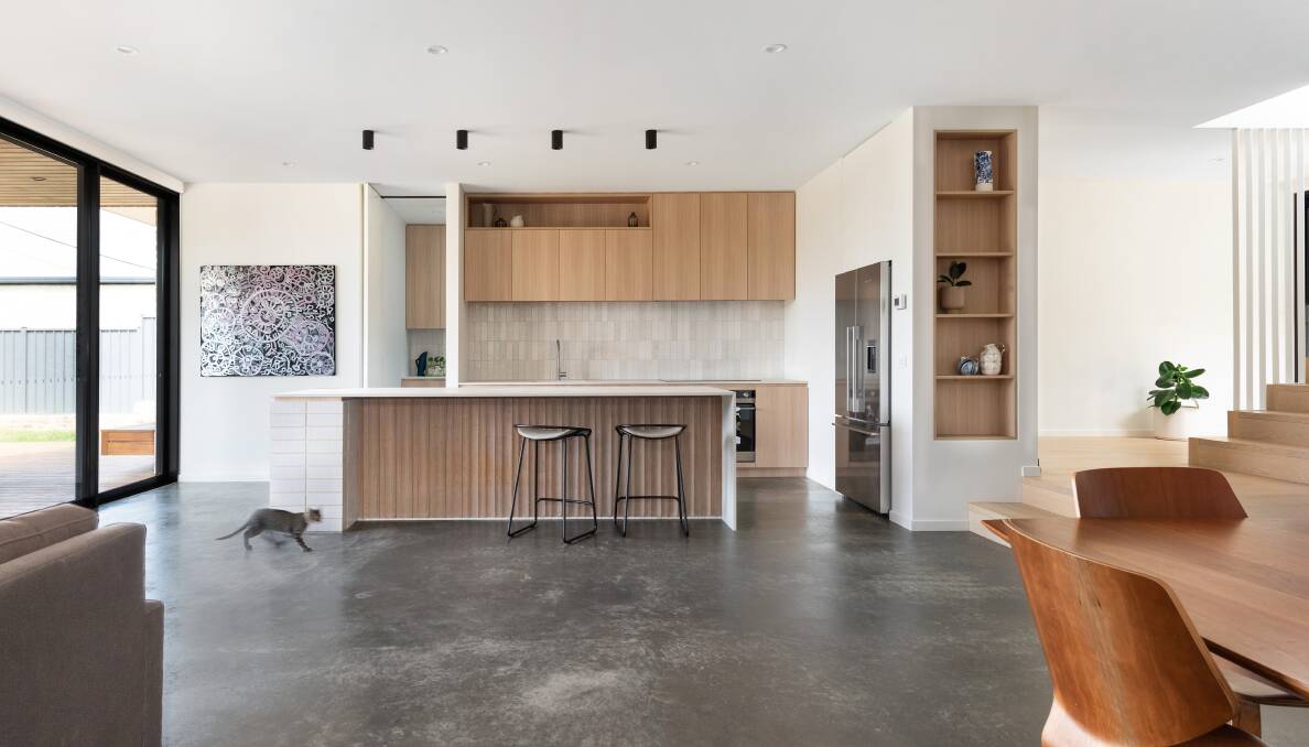 The kitchen has a large north-east facing window to funnel sun onto the exposed concrete floor. 