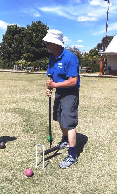On the green: Peter Freer, seen here in Goulburn last week, shared some of his vast knowledge with Goulburn's croquet players, and was joined by Kate McLoughlin. Photo: Supplied.