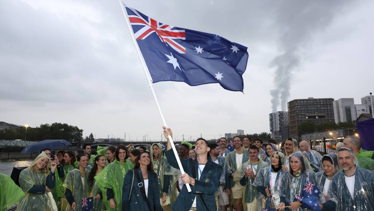 The Australian team braved rain at the opening ceremony. Picture AAP