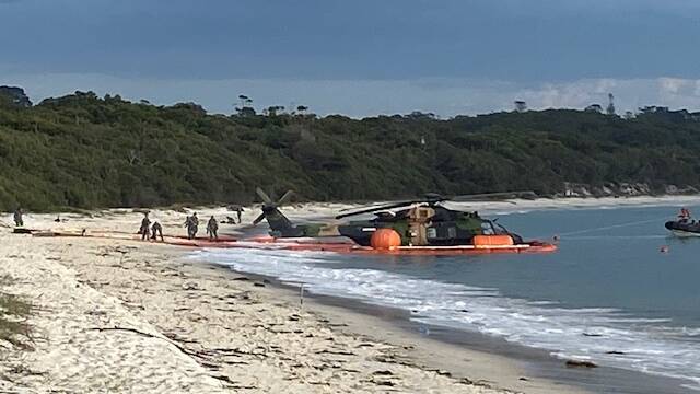 The ADF MRH-90 Taipan at Greenpatch Beach on Thursday morning after a crash on Wednesday evening where 10 people were rescued from the water off Jervis Bay. Picture by Glenn Ellard.