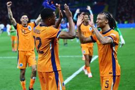 Netherlands players Denzel Dumfries (left) and Nathan Ake celebrate the win over Turkey. (EPA PHOTO)