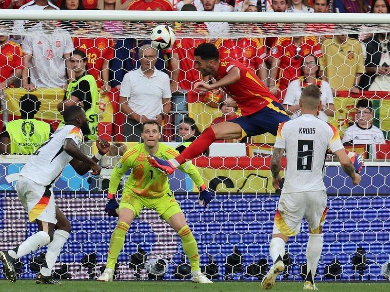 Mikel Merino leaps to end the hopes of hosts Germany by heading home Spain's late winner. (EPA PHOTO)