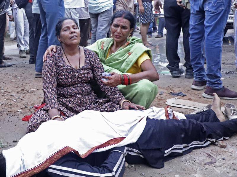 More than 120 people were killed and scores injured in a stampede at a Hindu gathering in India. (AP PHOTO)