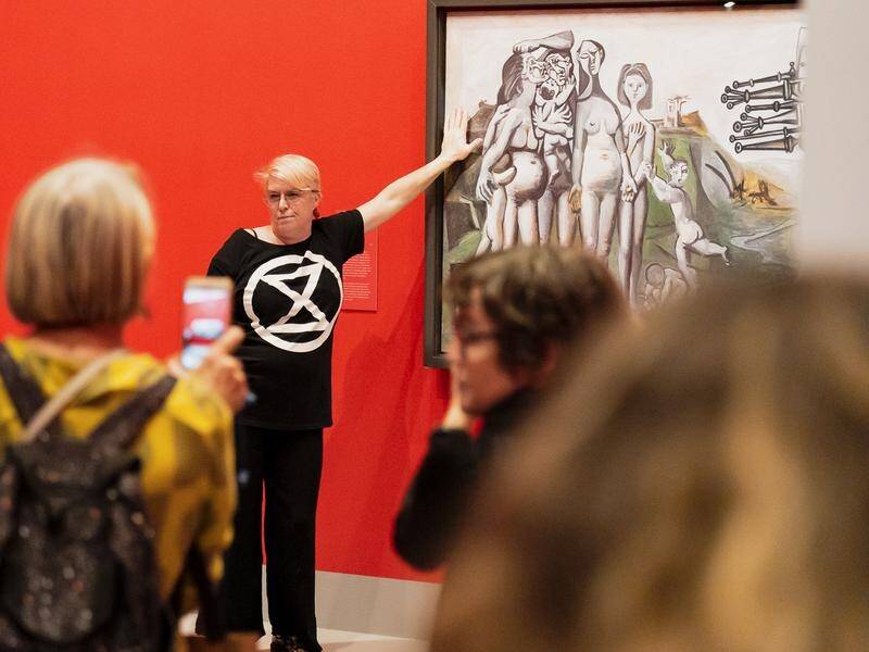 Two Extinction Rebellion protesters glued their hands to a Picasso in Melbourne. (PR HANDOUT IMAGE PHOTO)