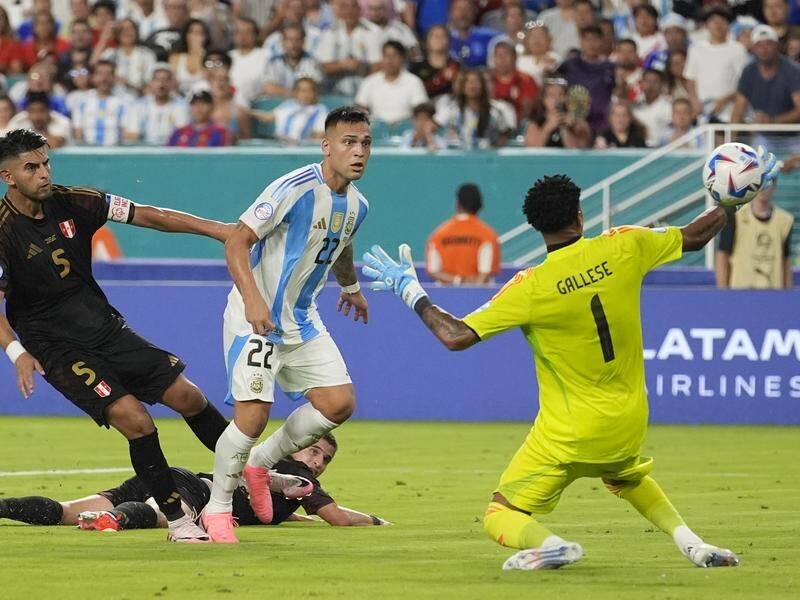 Lautaro Martinez (22) chips Pedro Gallese to put Argentina 2-0 up at Copa America. (AP PHOTO)