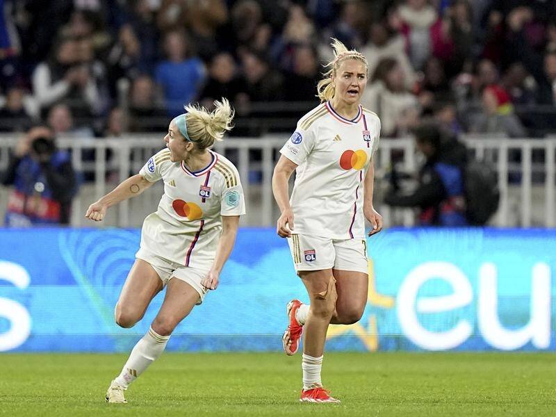 Lyon's Ellie Carpenter (L) and Lindsey Horan celebrate after Lyon's opener in their win over PSG. (AP PHOTO)