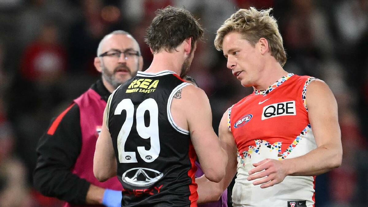 Isaac Heeney checks on Jimmy Webster's health after the tackle which saw the Sydney star suspended. (Joel Carrett/AAP PHOTOS)