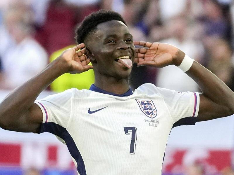 Bukayo Saka welcomes the cheers of England fans after converting his penalty against Switzerland. (AP PHOTO)