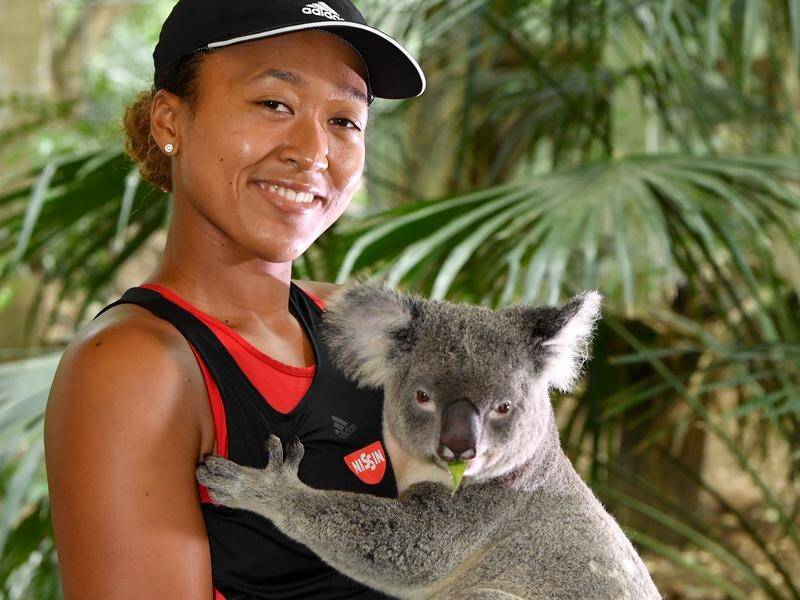Tennis champion Naomi Osaka holds a koala at Lone Pine Koala Sanctuary in Brisbane in 2018. (Darren England/AAP PHOTOS)